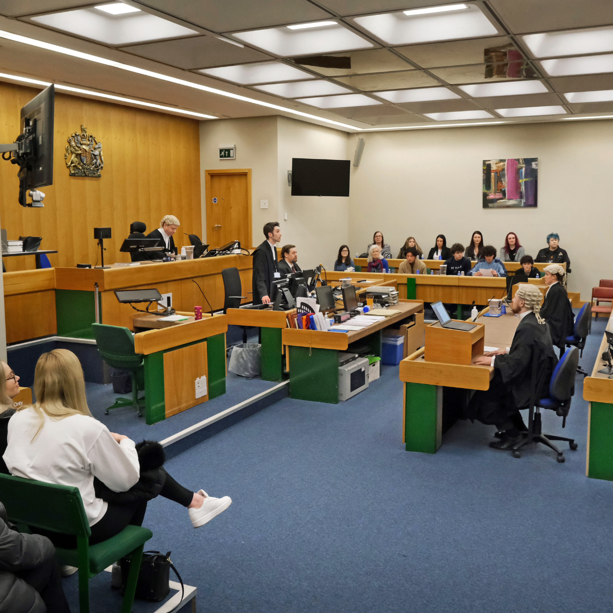 Taz teaching aspiring barristers inside a courtroom